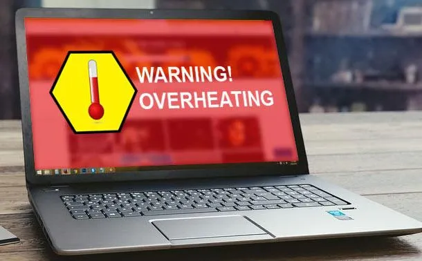 A laptop screen displays a red warning message with a thermometer icon, indicating a critical "WARNING! OVERHEATING" issue.